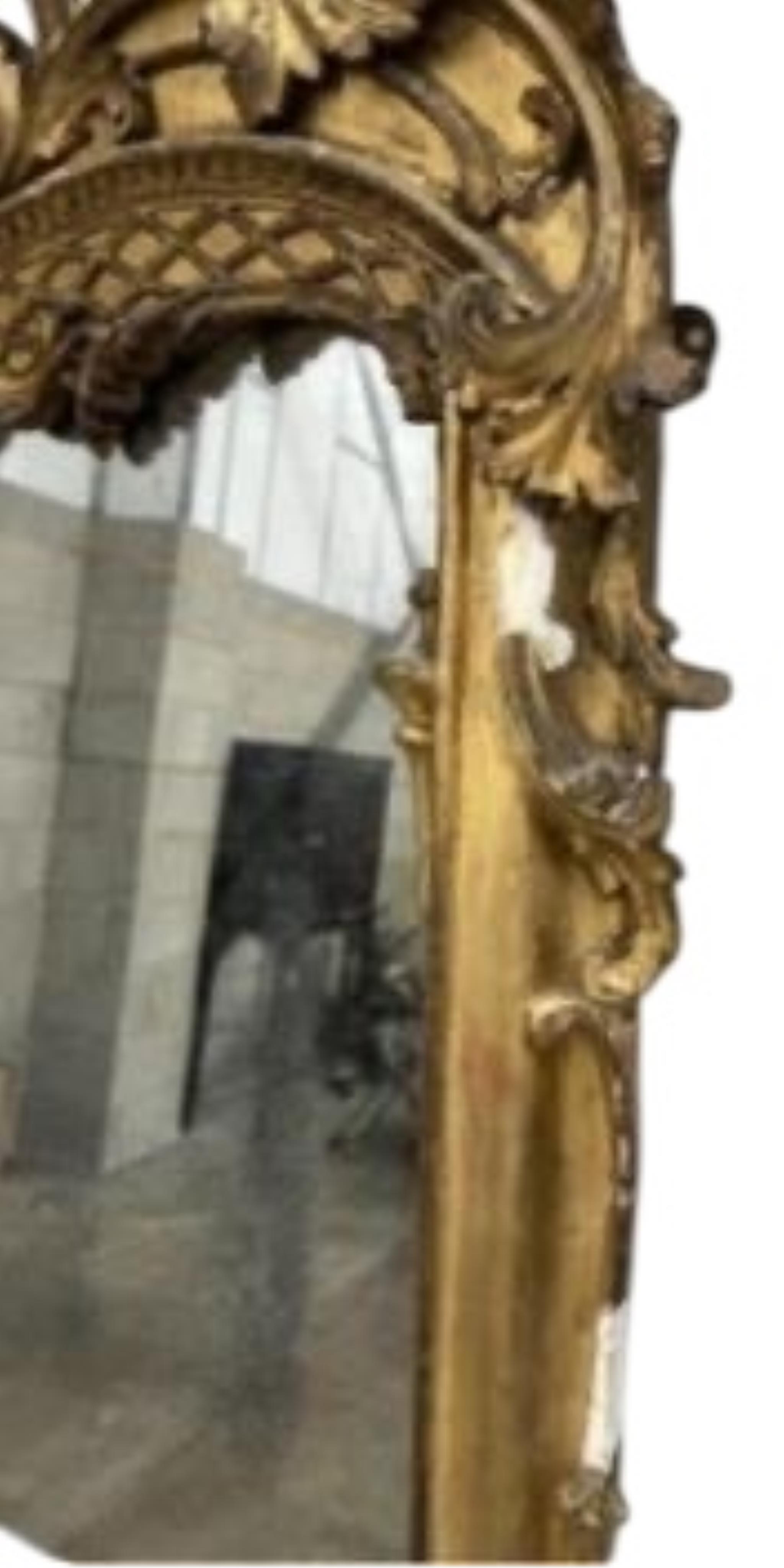 A Victorian carved giltwood and composition marble topped serpentine console table and mirror, width 132cm, height 177cm.